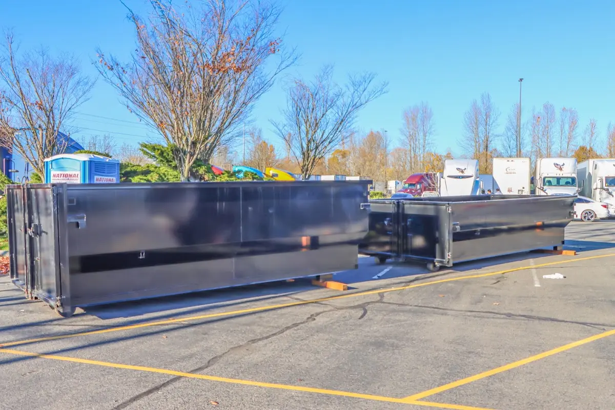 Professional dumpster rental service with roll-off container on residential driveway in Ellettsville